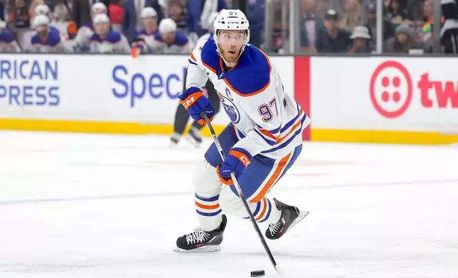 Edmonton Oilers center Connor McDavid moves the puck during the first period of an NHL hockey game against the Los Angeles Kings, Saturday, April 11, 2026, in Los Angeles. (AP Photo/Ryan Sun)