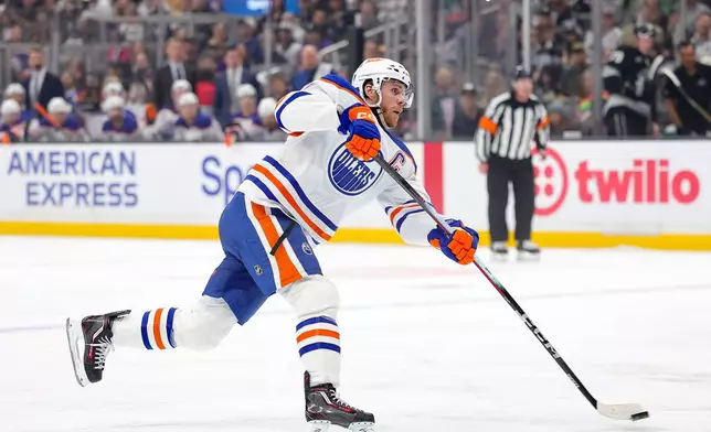 Edmonton Oilers center Connor McDavid shoots during the first period of an NHL hockey game against the Los Angeles Kings, Saturday, April 11, 2026, in Los Angeles. (AP Photo/Ryan Sun)
