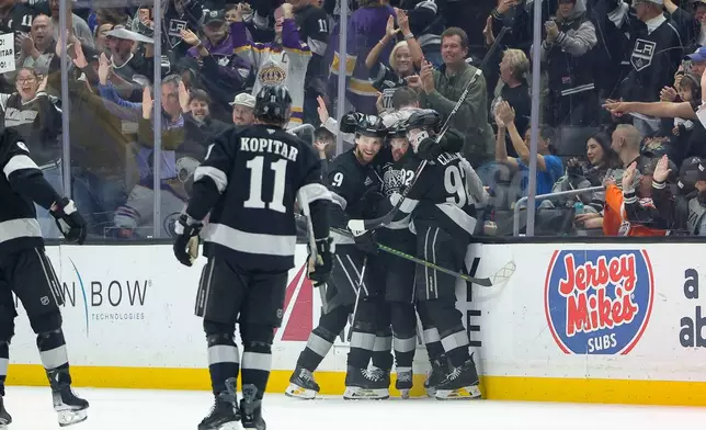 Los Angeles Kings left wing Artemi Panarin, second from right, celebrates with center Anze Kopitar (11), right wing Adrian Kempe (9), and defenseman Brandt Clarke (92) after scoring during the first period of an NHL hockey game against the Edmonton Oilers, Saturday, April 11, 2026, in Los Angeles. (AP Photo/Ryan Sun)