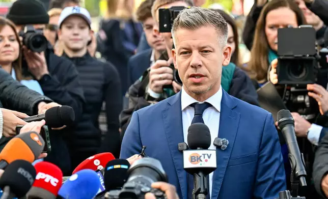 Peter Magyar, leader of the opposition Tisza party, speaks to the media outside a polling station in Budapest, Hungary, Sunday, April 12, 2026. (AP Photo/Denes Erdos)