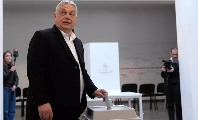 Hungary's Prime Minister Viktor Orban casts his vote in Budapest, Hungary, Sunday, April 12, 2026. (AP Photo/Petr David Josek)