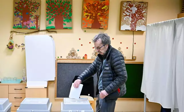 A man casts his ballot at a polling station in Budapest, Hungary, Sunday, April 12, 2026. (AP Photo/Denes Erdos)
