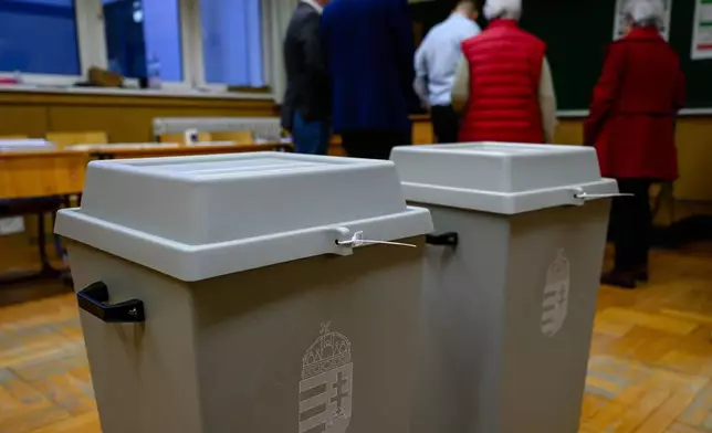 Officially sealed ballot boxes are seen at a local polling station during an election in Szekesfehervar, Hungary, Sunday, April 12, 2026. (Tamas Vasvari/MTI via AP)