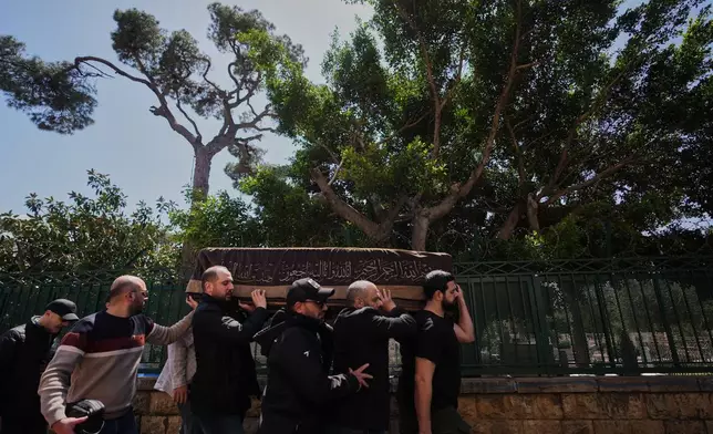Mourners carry the coffin of Mohammad Zein al-Abedin Shehab, who was killed in an Israeli airstrike a day earlier, during his funeral procession in Beirut, Lebanon, Thursday, April 9, 2026. (AP Photo/Hassan Ammar)