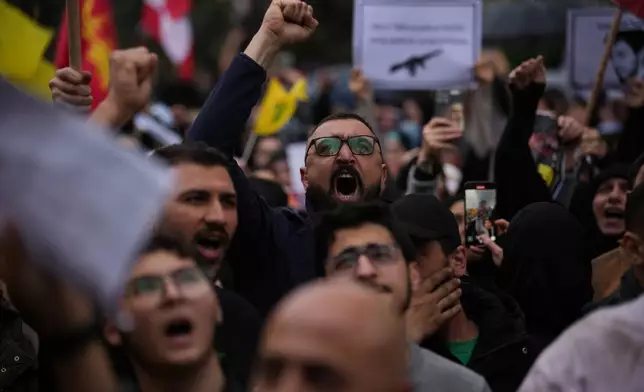 Hezbollah supporters shout slogans against the Lebanese Prime Minister Nawaf Salam during a protest in front the government palace, in Beirut, Lebanon, Friday, April 10, 2026. (AP Photo/Emilio Morenatti)