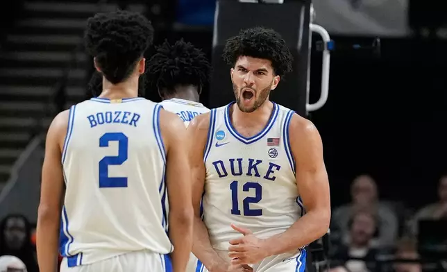 Duke forward Cameron Boozer (12) reacts after scoring during the second half in the second round of the NCAA college basketball tournament against TCU, Saturday, March 21, 2026, in Greenville, S.C. (AP Photo/Brynn Anderson)