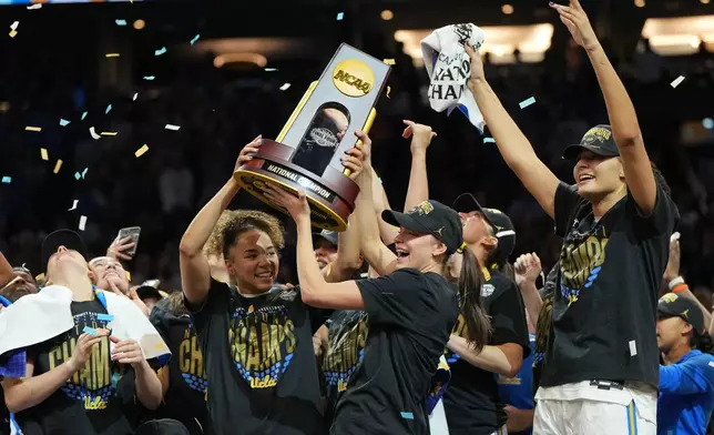 UCLA players celebrate after defeating South Carolina in the women's National Championship Final Four NCAA college basketball tournament game, Sunday, April 5, 2026, in Phoenix. (AP Photo/Rick Scuteri)