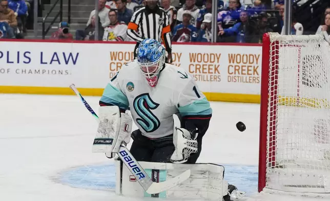 Seattle Kraken goaltender Victor Ostman deflects a shot in the first period of an NHL hockey game against the Colorado Avalanche, Thursday, April 16, 2026, in Denver. (AP Photo/David Zalubowski)