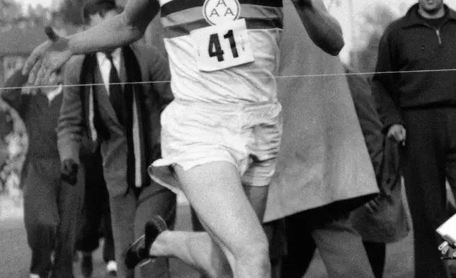 FILE - In this May 6, 1954, file photo, British Athlete Roger Bannister breaks the tape to become the first man ever to break the four minute barrier in the mile at Iffly Field in Oxford, England. (AP Photo/File)