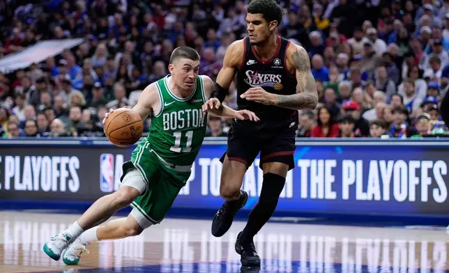 Boston Celtics' Payton Pritchard, left, tries to get past Philadelphia 76ers' Dominick Barlow during the first half of Game 4 in a first-round NBA basketball playoffs series Sunday, April 26, 2026, in Philadelphia. (AP Photo/Matt Slocum)