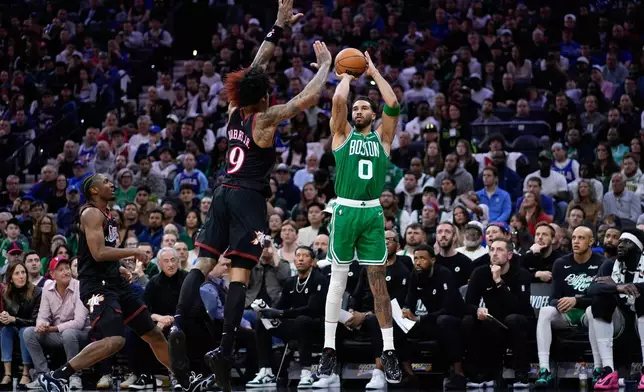 Boston Celtics' Jayson Tatum (0) goes up for a shot against Philadelphia 76ers' Kelly Oubre Jr. (9) during the first half of Game 4 in a first-round NBA basketball playoffs series Sunday, April 26, 2026, in Philadelphia. (AP Photo/Matt Slocum)