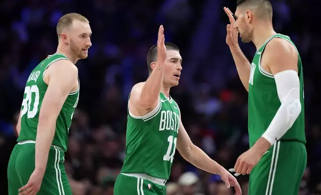 Boston Celtics' Sam Hauser, from left, Payton Pritchard and Nikola Vucevic react during the first half of Game 4 against the Philadelphia 76ers in a first-round NBA basketball playoffs series Sunday, April 26, 2026, in Philadelphia. (AP Photo/Matt Slocum)