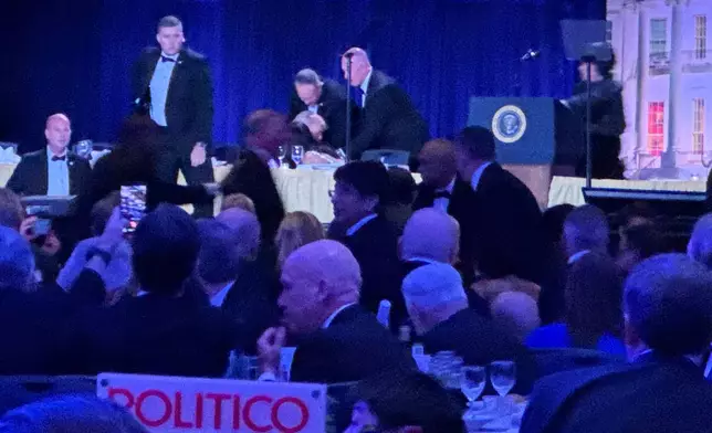 Secret service agents respond during the White House Correspondents Dinner, Saturday, April 25, 2026, in Washington. (AP Photo/Mark Schiefelbein)