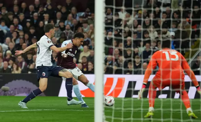 Aston Villa's Morgan Rogers scores his side's third goal during the Europa League quarterfinal second leg soccer match between Aston Villa and Bologna, in Birmingham, England, Thursday, April 16, 2026. (AP Photo/Dave Shopland)