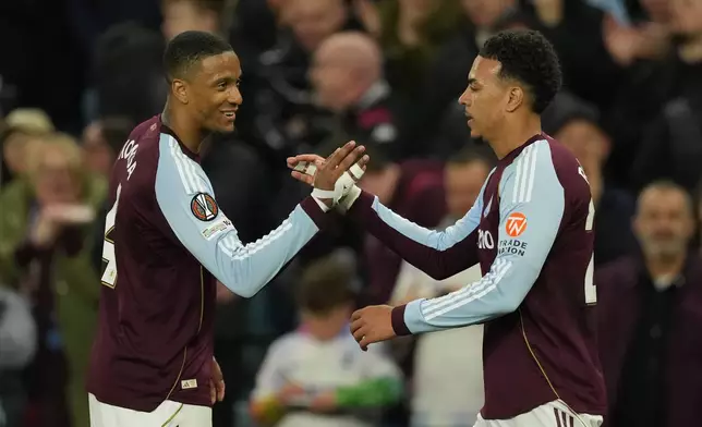 Aston Villa's Morgan Rogers, right, celebrates after scores his side's third goal during the Europa League quarterfinal second leg soccer match between Aston Villa and Bologna, in Birmingham, England, Thursday, April 16, 2026. (AP Photo/Dave Shopland)