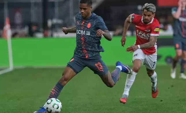 Shakhtar's Pedrinho in action in front of AZ Alkmaar's Weslley Patati during the Conference League second-leg quarterfinal soccer match between AZ Alkmaar and Shakhtar Donetsk in Alkmaar, Netherlands, Thursday, April 16, 2026. (AP Photo/Patrick Post)