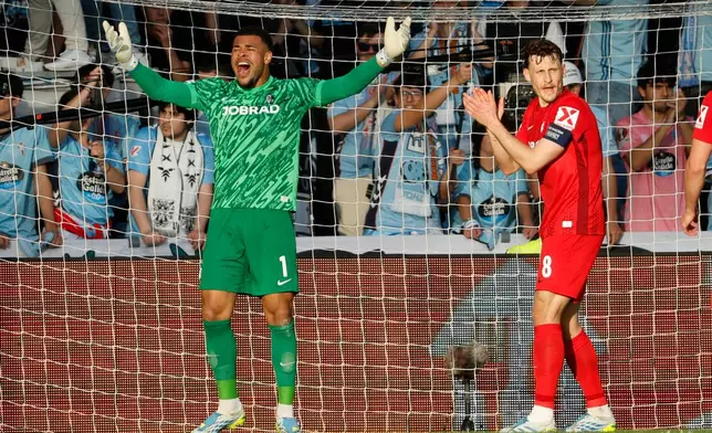 Freiburg's goalkeeper Noah Atubolu celebrates after saving during the Europa League quarterfinal second leg soccer match between Celta Vigo and Freiburg in Vigo, Spain, Thursday, April 16, 2026. (AP Photo/Lalo R. Villar)