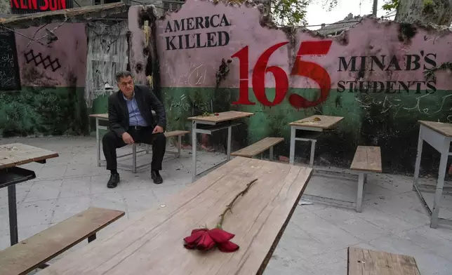 FILE - A man sits on a bench in a memorial, set for the school children who were killed during a strike on a school in southern town of Minab on Feb. 28, in northern Tehran, Iran, Sunday, April 12, 2026. (AP Photo/Vahid Salemi, File)
