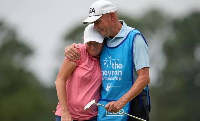 Stacy Lewis gets a hug from her caddie and father Dale on the 18th hole after the second round of the Chevron Championship LPGA golf tournament Friday, April 24, 2026, in Houston. (AP Photo/Ashley Landis)