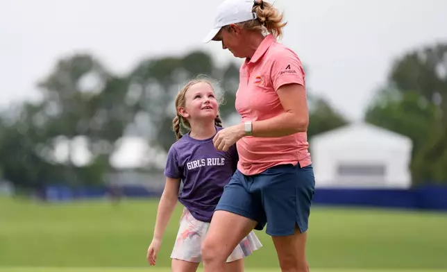 Stacy Lewis is greeted by her daughter Chesnee on the 18th green after the second round of the Chevron Championship LPGA golf tournament Friday, April 24, 2026, in Houston. (AP Photo/Ashley Landis)