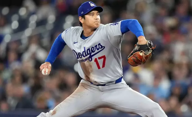 Los Angeles Dodgers pitcher Shohei Ohtani (17) throws during first inning of a baseball against the Toronto Blue Jays in Toronto, Wednesday, April 8, 2026. (Nathan Denette/The Canadian Press via AP)