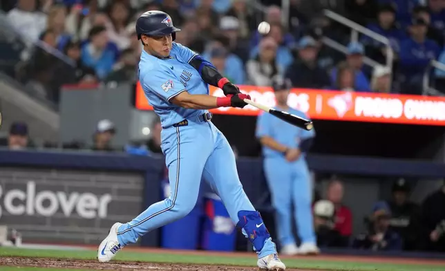 Toronto Blue Jays third baseman Kazuma Okamoto (7) pops out against the Los Angeles Dodgers during the sixth inning of a baseball game in Toronto, Wednesday, April 8, 2026. (Nathan Denette/The Canadian Press via AP)