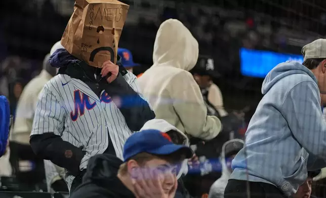 Mets fans watch during the eighth inning of a baseball game between the New York Mets and the Minnesota Twins Tuesday, April 21, 2026, in New York. (AP Photo/Frank Franklin II)
