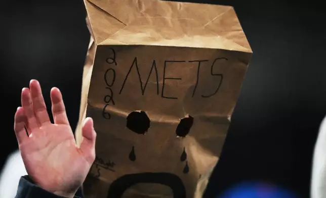 A New York Mets fan watches during the eighth inning of a baseball game against the Minnesota Twins Tuesday, April 21, 2026, in New York. (AP Photo/Frank Franklin II)