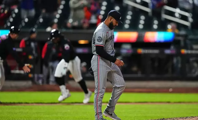 Minnesota Twins pitcher Simeon Woods Richardson, right, reacts as New York Mets' Francisco Lindor runs the bases after hitting a three-run home run during the third inning of a baseball game Tuesday, April 21, 2026, in New York. (AP Photo/Frank Franklin II)