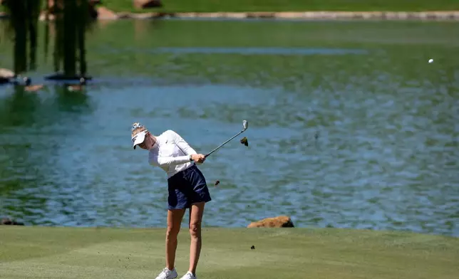 Nelly Korda hits an approach shot on the fourth hole during the final round of the Aramco Championship golf tournament Sunday, April 5, 2026, in North Las Vegas, Nev. (AP Photo/Ian Maule)