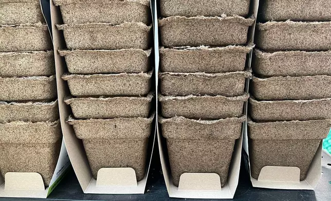 Packages of plastic-free, manure-based planting pots appear on Long Island, N.Y., on April 8, 2026. (Jessica Damiano via AP)