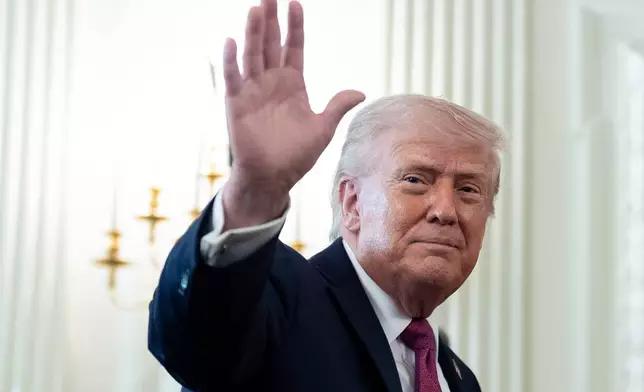 President Donald Trump waves as he departs after an event for NCAA national champions in the State Dining Room of the White House, Tuesday, April 21, 2026, in Washington. (AP Photo/Alex Brandon)