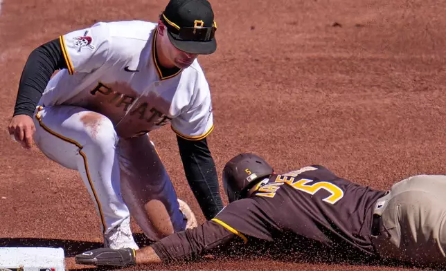 San Diego Padres' Ramón Laureano (5) gets into third ahead of the tag by Pittsburgh Pirates third baseman Nick Yorke during the sixth inning of a baseball game in Pittsburgh, Wednesday, April 8, 2026. (AP Photo/Gene J. Puskar)