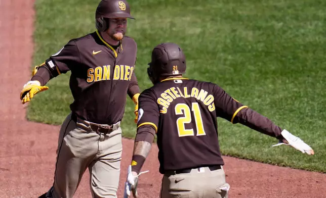 San Diego Padres' Jake Cronenworth, left, is greeted by Nick Castellanos (21) after hitting a two-run home run off Pittsburgh Pirates pitcher Justin Lawrence during the seventh inning of a baseball game in Pittsburgh, Wednesday, April 8, 2026. (AP Photo/Gene J. Puskar)