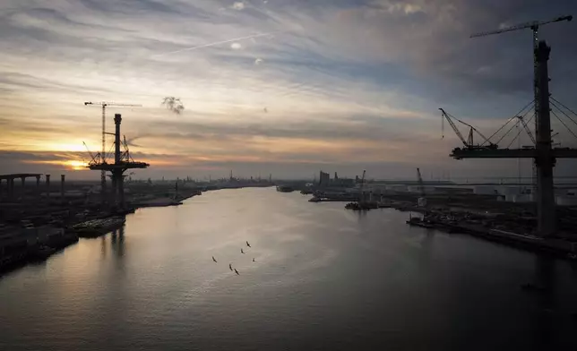 Birds fly over the Port of Corpus Christi as the sun sets Thursday, Nov. 16, 2023, in Corpus Christi, Texas. (Jon Shapley/Houston Chronicle via AP)