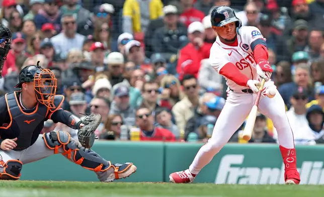 Boston Red Sox' Ceddanne Rafaela hits a two run pinch hit single down the right field line in the seventh inning during a baseball game against the Detroit Tigers, Monday, April 20, 2026 in Boston. (AP Photo/Jim Davis)