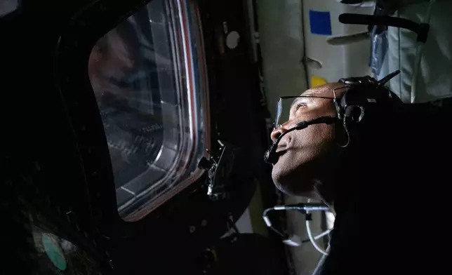 In this image provided by NASA, Artemis II Pilot Victor Glover is photographed in the Orion spacecraft during the Artemis II lunar flyby on Monday, April 6, 2026. (NASA via AP)