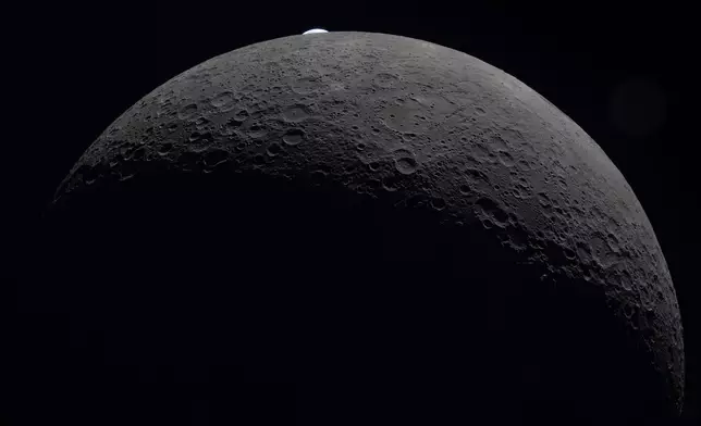 In this image provided by NASA, the Artemis II crew photographed the the lunar surface of the Moon on Monday, April 6, 2026. (NASA via AP)