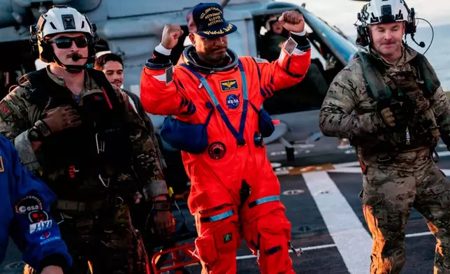 This photo provided by the U.S. Navy, NASA astronaut Victor Glover celebrates on the flight deck of the USS John P. Murtha (LPD 26) off the coast of California after returning from space on Friday, April 10, 2026.(Mass Communication Specialist 2nd Class August Clawson/U.S. Navy via AP)