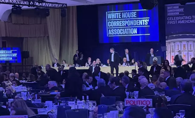 U.S. Secret Service agents respond near President Donald Trump during the White House Correspondents Dinner, Saturday, April 25, 2026, in Washington. (AP Photo/Alex Brandon)