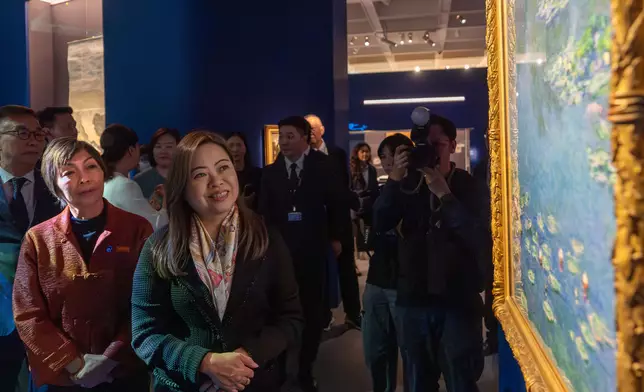 Guests tour the “Blooming: The Art of Gardens in East and West” exhibition.