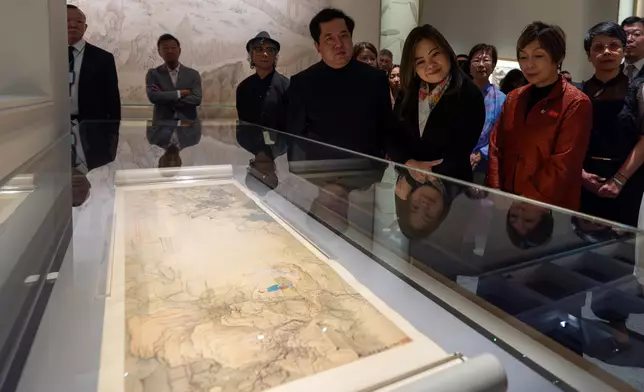 Guests tour the “Blooming: The Art of Gardens in East and West” exhibition.