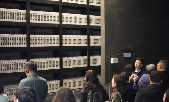 On either side of the hall are 18 niches containing 18 iron books, engraved with the names of nearly 11,000 confirmed victims. Photo by Bastille Post