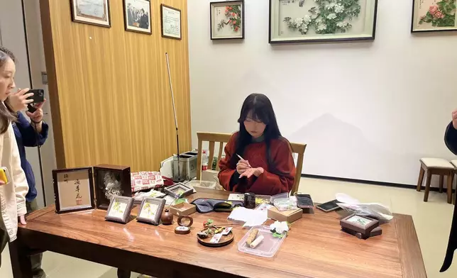 A young inheritor at the Treasure Hall, 28-year-old Wang Yunyu, has devoted herself to the art of sola flower making for over a decade, making her the youngest and earliest apprentice of master Mr. Dai Chunfu. Photo by Bastille Post