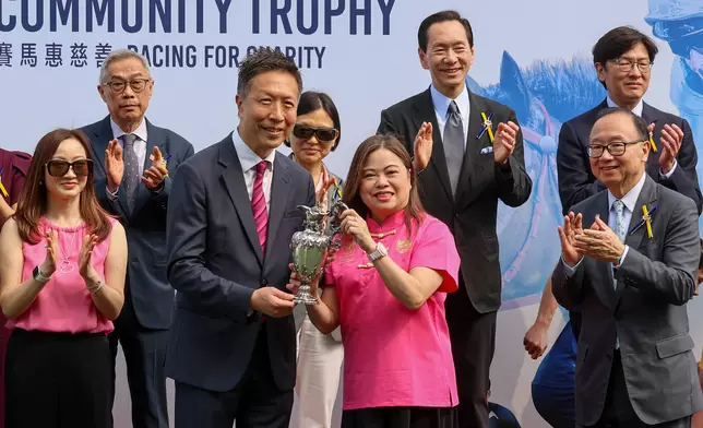 The Hon Rosanna Law, Secretary for Culture, Sports and Tourism (right), presents The Hong Kong Jockey Club Community Trophy to Alan Hu (left), owner of the winning horse Absolute Honour. The historic 170-year-old trophy was generously donated by the late Tobias Brown in recognition of the Club’s charitable contributions to the community.