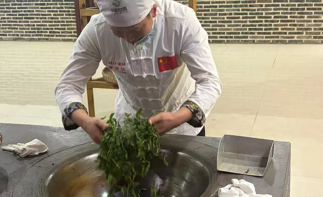 "Killing green" (shaqing) and "extracting aroma" by Chinese tea master Mr. Tang Shijiang, Photo by Bastille Post