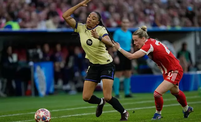 Barcelona's Salma Paralluelo, left, is fouled by Bayern's Franziska Kett during the Women's Champions League semifinal first leg soccer match between Bayern Munich and Barcelona in Munich, Germany, Saturday, April 25, 2026. (AP Photo/Matthias Schrader)