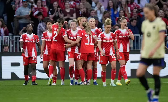 Bayern's Franziska Kett, center, celebrates after scoring her side's first goal during the Women's Champions League semifinal first leg soccer match between Bayern Munich and Barcelona in Munich, Germany, Saturday, April 25, 2026. (AP Photo/Matthias Schrader)