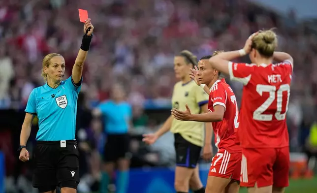 Bayern's Franziska Kett, right, gets a red card by referee Ivana Martincic during the Women's Champions League semifinal first leg soccer match between Bayern Munich and Barcelona in Munich, Germany, Saturday, April 25, 2026. (AP Photo/Matthias Schrader)