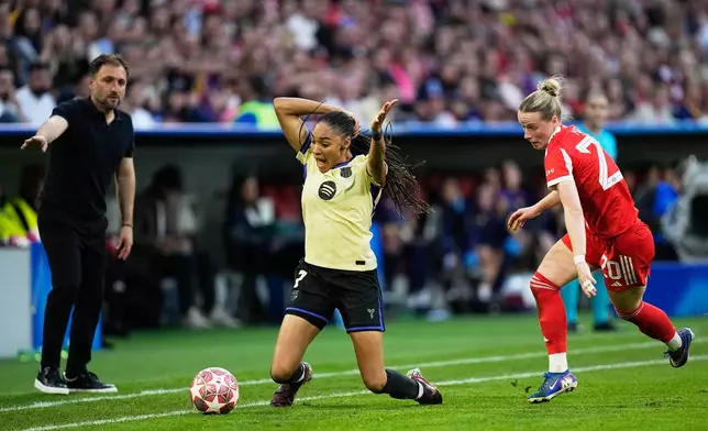 Barcelona's Salma Paralluelo, left, is fouled by Bayern's Franziska Kett during the Women's Champions League semifinal first leg soccer match between Bayern Munich and Barcelona in Munich, Germany, Saturday, April 25, 2026. (AP Photo/Matthias Schrader)